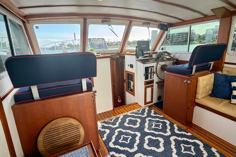 Slide: The Image of Interior of 1987 Wilbur Flybridge Cruiser with nautical decor and wooden accents. - 38