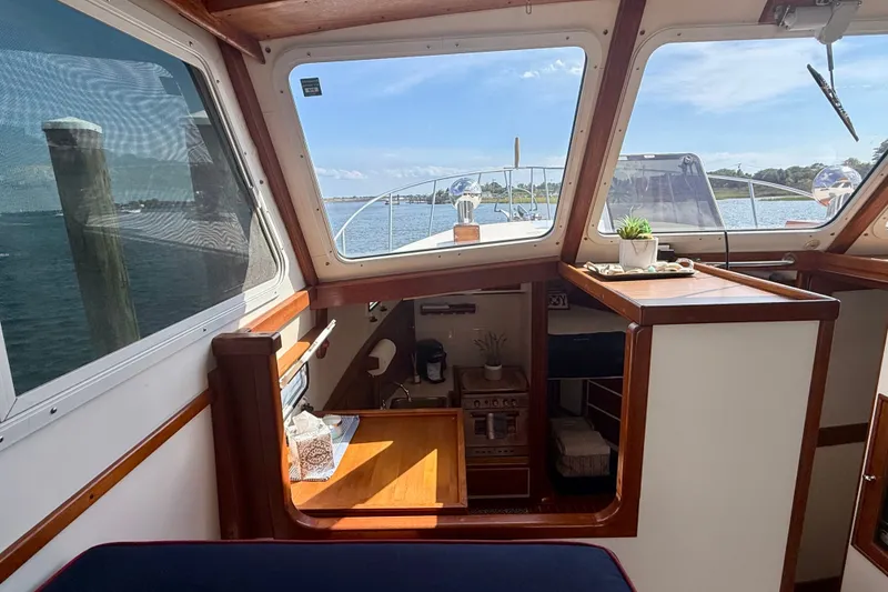 Slide: The Image of Interior of 1987 Wilbur Flybridge Cruiser with wooden accents and scenic water view. - 45
