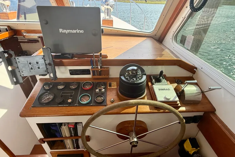 Slide: The Image of 1987 Wilbur Flybridge Cruiser helm with Raymarine and Simrad navigation equipment. - 44