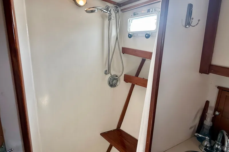 Slide: The Image of Shower area in 1987 Wilbur Flybridge Cruiser with wooden accents and window. - 53
