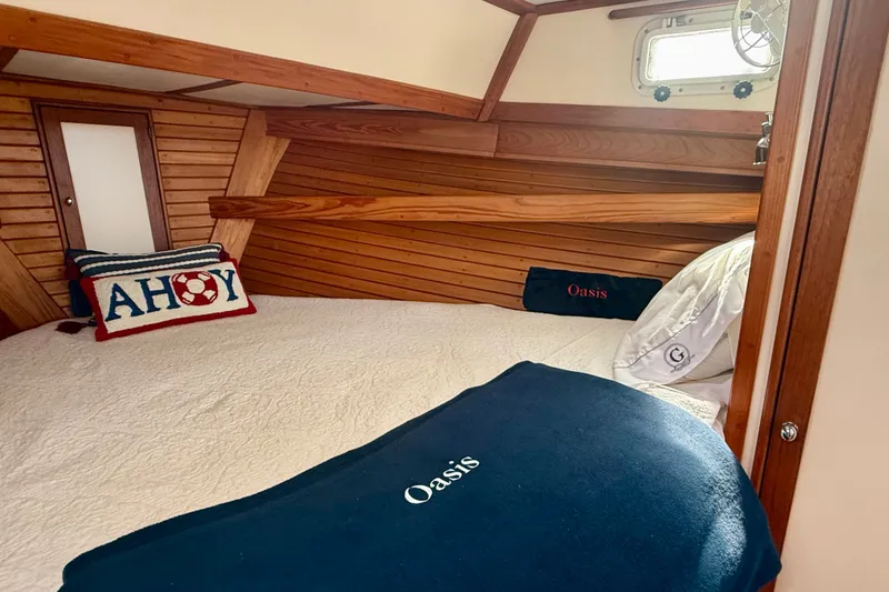 Slide: The Image of Cozy cabin interior of 1987 Wilbur Flybridge Cruiser with nautical-themed pillows. - 56