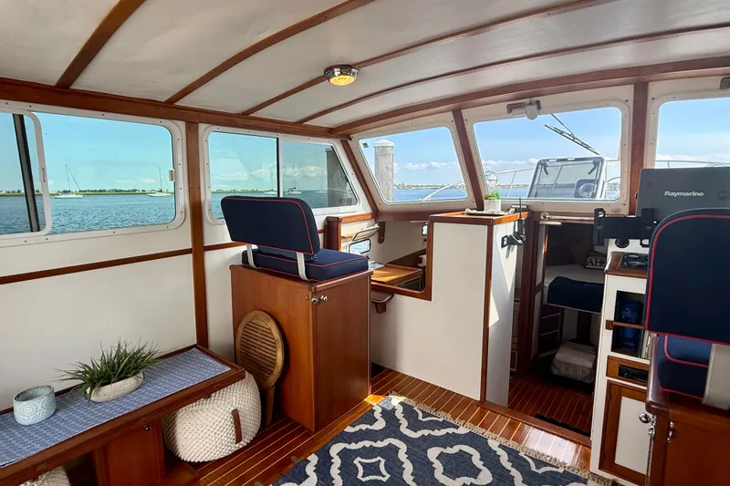 Slide: The Image of 1987 Wilbur Flybridge Cruiser interior with wooden accents and nautical decor. - 39