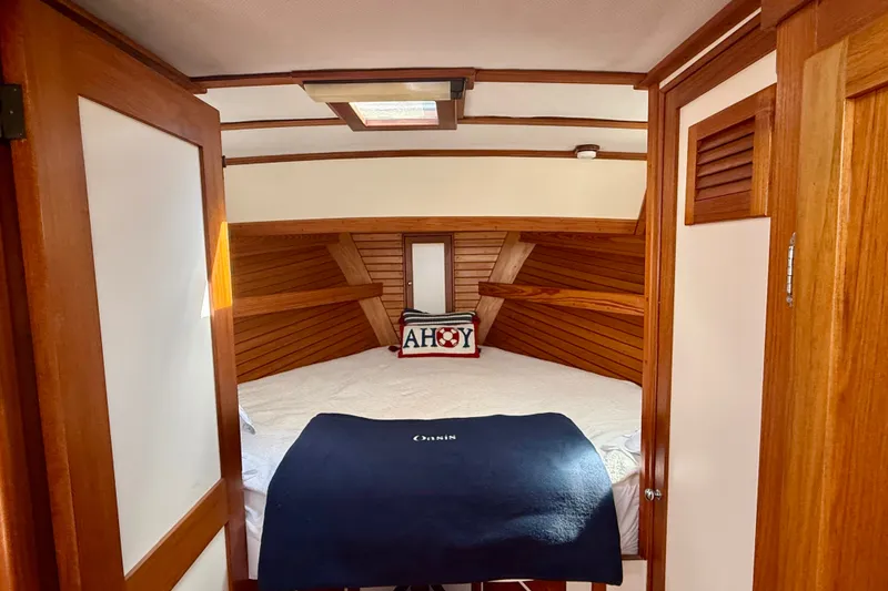 Slide: The Image of Cozy cabin interior of 1987 Wilbur Flybridge Cruiser with wooden accents and nautical decor. - 55