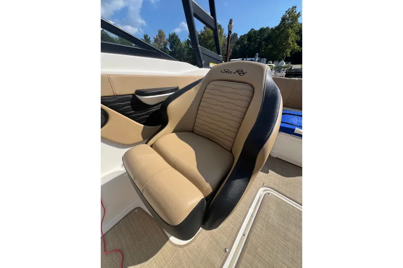 Slide: The Image of 2022 Sea Ray SPX 210 boat seat, tan and black upholstery, sunny day. - 18