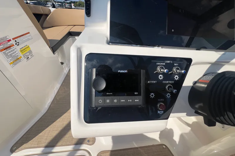 Slide: The Image of Control panel of a 2022 Sea Ray SPX 210 boat with audio system and switches. - 27