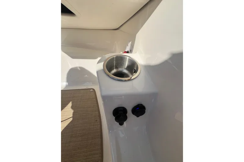 Slide: The Image of Cup holder and controls on 2022 Sea Ray SPX 210 boat interior. - 40