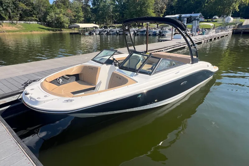 The Image of 2022 Sea Ray SPX 210 boat docked on a serene lake with lush greenery. - 0