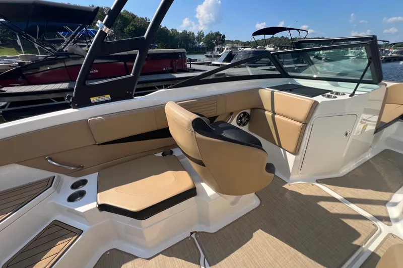 Slide: The Image of 2022 Sea Ray SPX 210 boat interior with tan seating and modern design. - 19