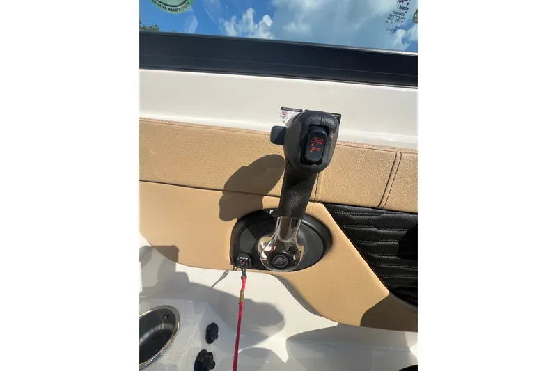 Slide: The Image of Throttle control of 2022 Sea Ray SPX 210 boat, featuring beige and black interior. - 41