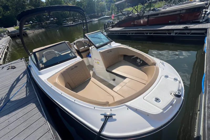 Slide: The Image of 2022 Sea Ray SPX 210 boat docked, featuring spacious seating and sleek design. - 13