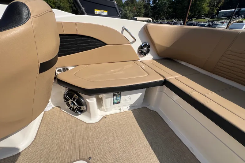 Slide: The Image of 2022 Sea Ray SPX 210 boat interior with tan seating and speaker system. - 24