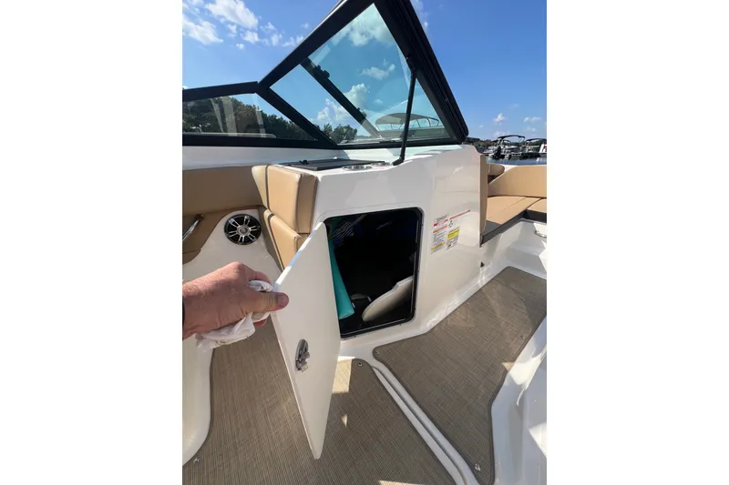 Slide: The Image of 2022 Sea Ray SPX 210 boat interior with open storage compartment and seating. - 39