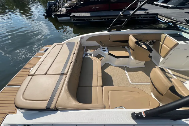 Slide: The Image of 2022 Sea Ray SPX 210 boat interior with tan seating and sleek design. - 16
