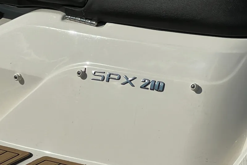 Slide: The Image of 2022 Sea Ray SPX 210 boat emblem on white surface. - 34