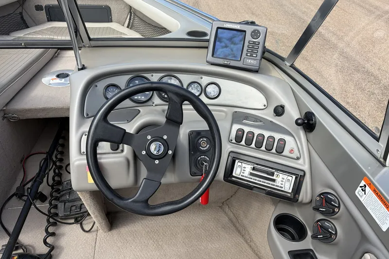 Slide: The Image of 2003 Lund 1850 Tyee OB boat dashboard with steering wheel and navigation system. - 4