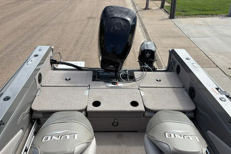 Slide: The Image of 2003 Lund 1850 Tyee OB boat interior with motor, seats, and storage compartments. - 5