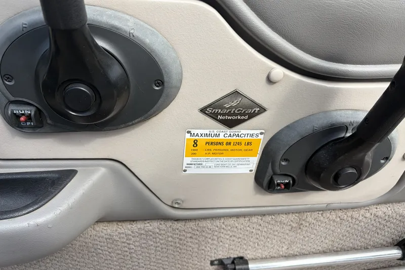 Slide: The Image of 2003 Lund 1850 Tyee OB boat controls with capacity label and SmartCraft networked system. - 8