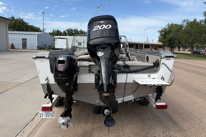 Slide: The Image of 2003 Lund 1850 Tyee OB boat with dual outboard motors on a trailer. - 2