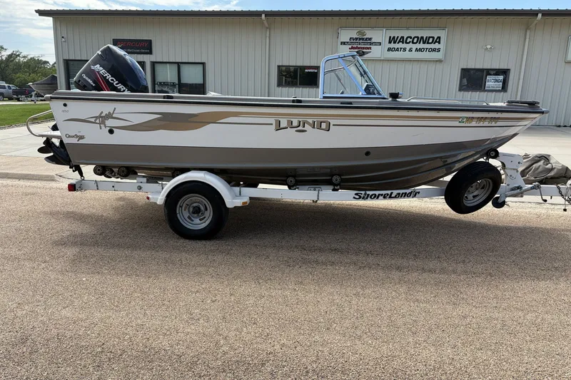 Slide: The Image of 2003 Lund 1850 Tyee OB boat on trailer outside dealership. - 1