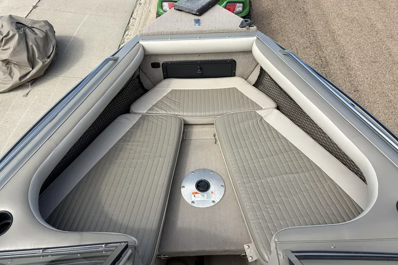 Slide: The Image of 2003 Lund 1850 Tyee OB boat interior with gray cushioned seating and storage compartments. - 7