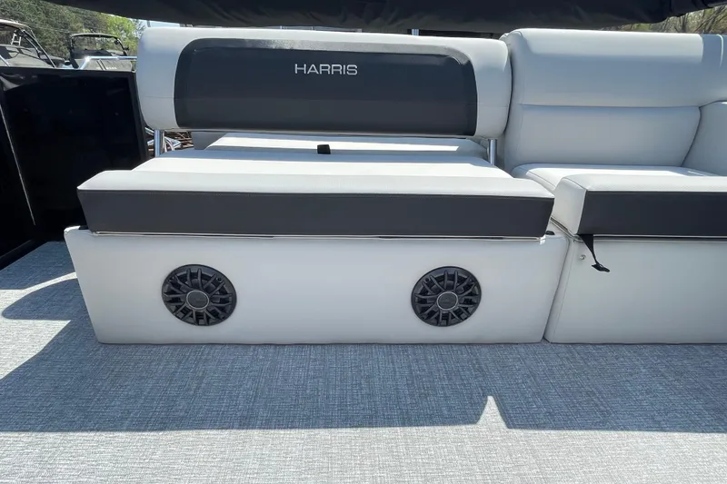 Slide: The Image of 2026 Harris Cruiser 230 SLDH boat seating with integrated speakers, featuring sleek gray upholstery. - 17