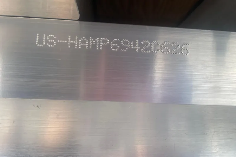 Slide: The Image of 2026 Harris Cruiser 230 SLDH hull identification number on metal surface. - 22