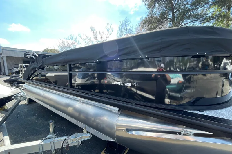 Slide: The Image of 2026 Harris Cruiser 230 SLDH pontoon boat with black cover on trailer. - 19