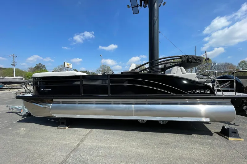 The Image of 2026 Harris Cruiser 230 SLDH pontoon boat on display under clear blue sky. - 1