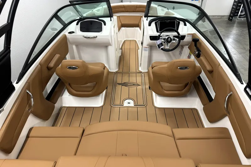 Slide: The Image of 2027 Chaparral 21 SSi boat interior with tan leather seats and sleek dashboard design. - 9