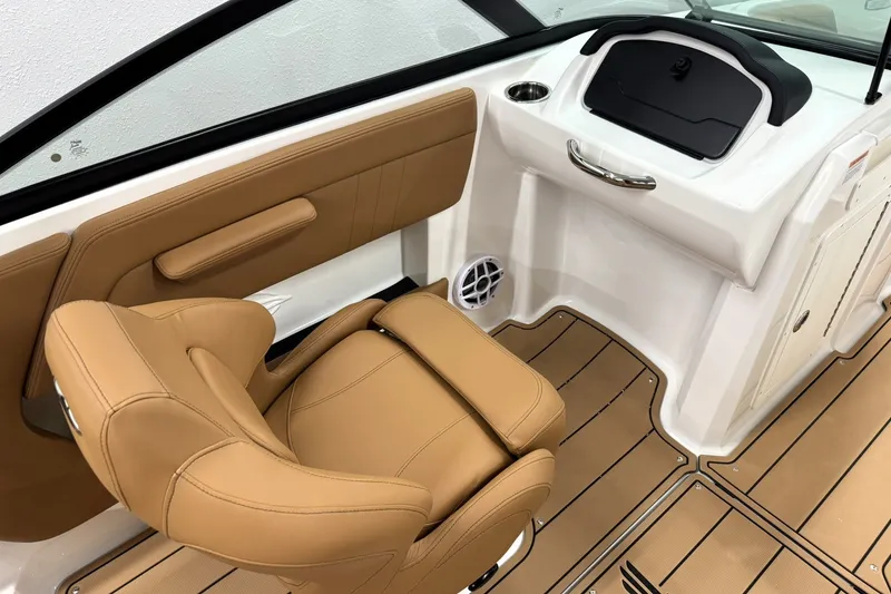 Slide: The Image of 2027 Chaparral 21 SSi boat interior with tan leather seating and sleek dashboard design. - 15
