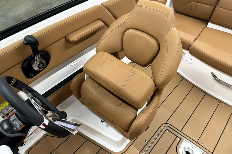 Slide: The Image of 2027 Chaparral 21 SSi boat interior with tan leather seating and steering wheel. - 14