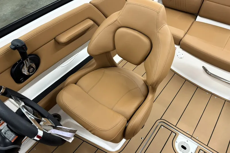 Slide: The Image of 2027 Chaparral 21 SSi boat interior with tan leather seating and steering wheel. - 13