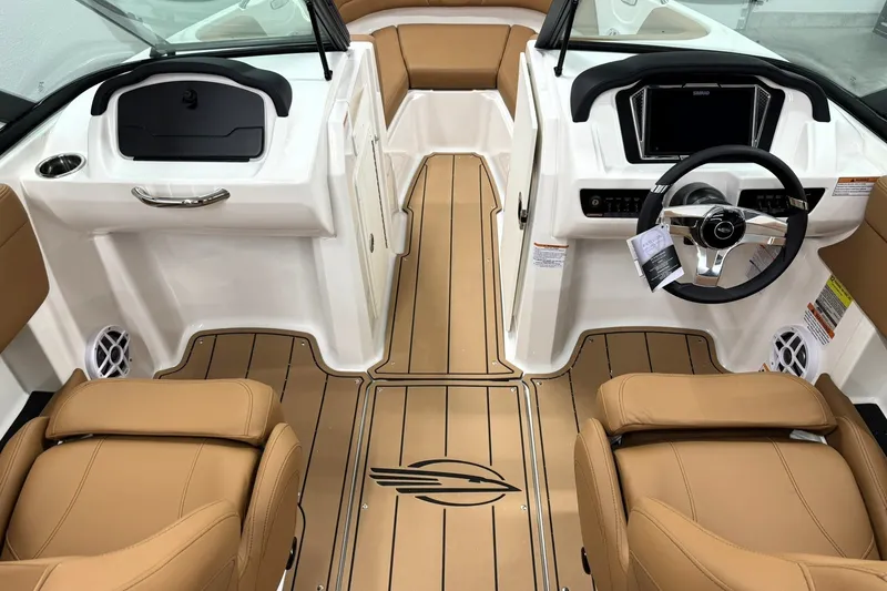 Slide: The Image of 2027 Chaparral 21 SSi boat interior with tan seating and modern dashboard design. - 10