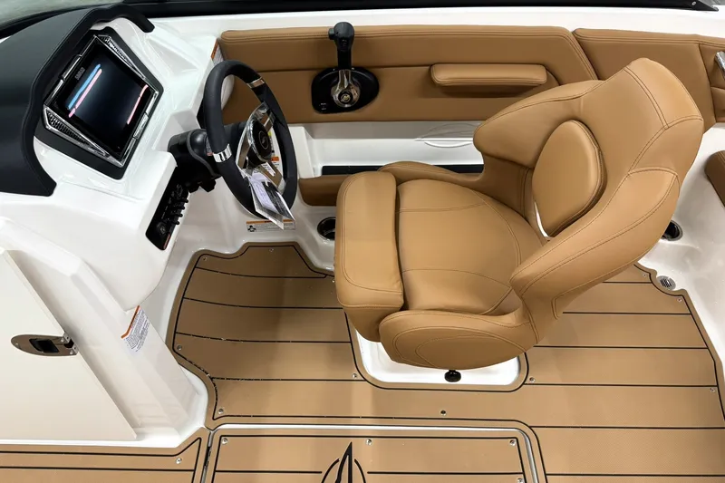 Slide: The Image of 2027 Chaparral 21 SSi boat interior with tan leather seat and modern dashboard. - 12