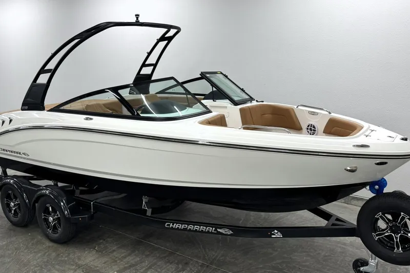 Slide: The Image of 2027 Chaparral 21 SSi boat on trailer, sleek design, white exterior, modern features. - 2