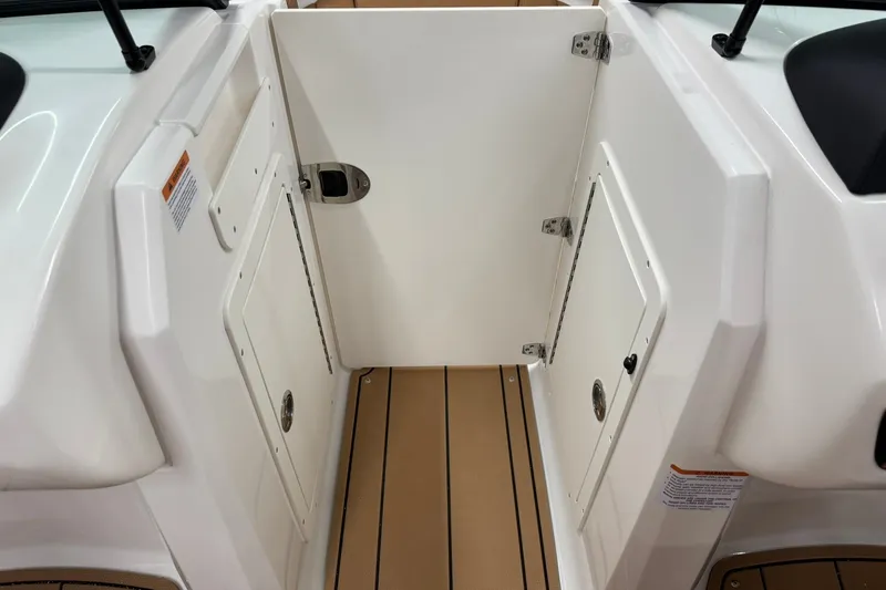 Slide: The Image of 2027 Chaparral 21 SSi boat interior with storage compartments and teak-style flooring. - 22