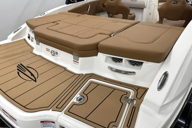 Slide: The Image of 2027 Chaparral 21 SSi boat with tan seating and deck, featuring sleek design elements. - 4