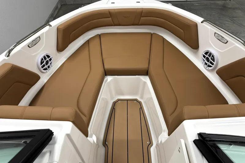 Slide: The Image of 2027 Chaparral 21 SSi boat interior with tan seating and white speakers. - 25
