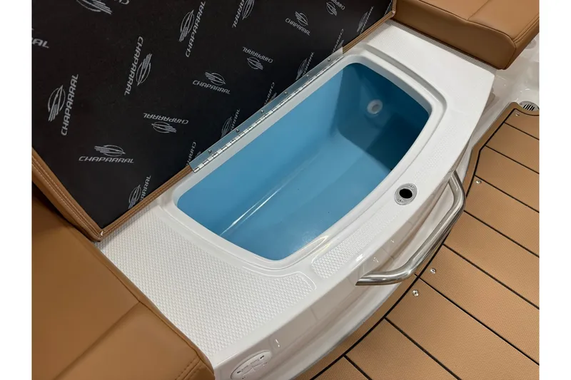 Slide: The Image of 2027 Chaparral 21 SSi boat interior with open storage compartment and cushioned seating. - 20