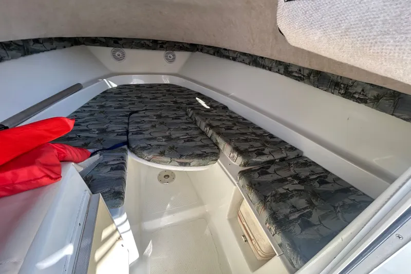Slide: The Image of 2006 Sailfish 234 WAC cabin interior with patterned cushions and red life jacket. - 20