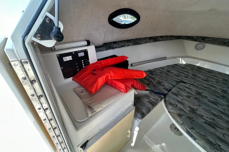 Slide: The Image of Interior of 2006 Sailfish 234 WAC boat cabin with life jackets and control panel. - 24