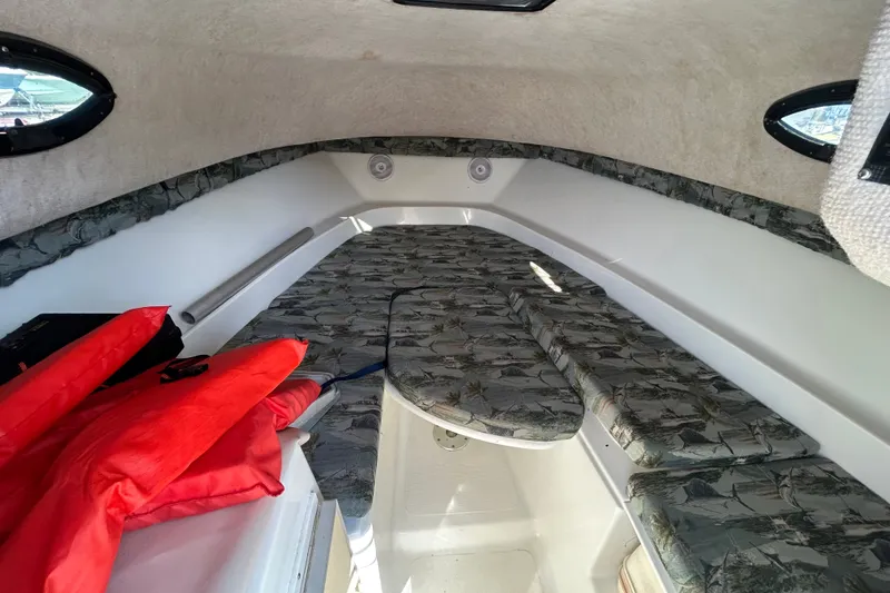Slide: The Image of Interior cabin of 2006 Sailfish 234 WAC boat with patterned cushions and life jackets. - 21