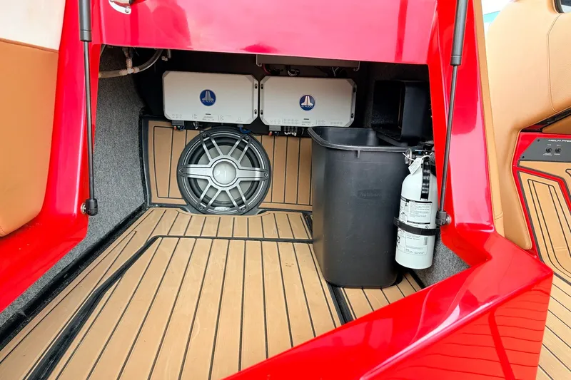 Slide: The Image of 2022 Nautique Super Air Nautique G25 interior storage with speaker and fire extinguisher. - 23