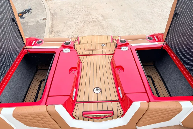 Slide: The Image of 2022 Nautique Super Air Nautique G25 boat with open storage compartments and teak flooring. - 49
