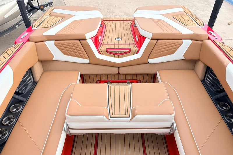 Slide: The Image of Luxurious interior of 2022 Nautique Super Air Nautique G25 boat with tan and white seating. - 28