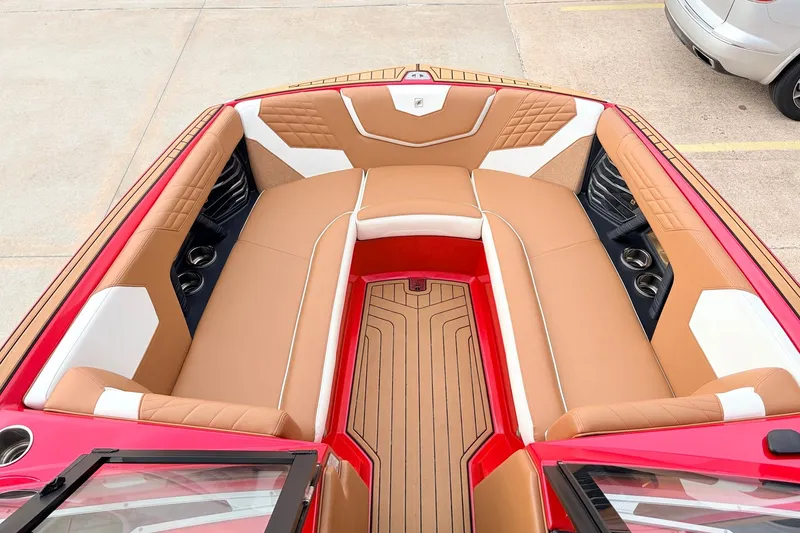Slide: The Image of 2022 Nautique Super Air Nautique G25 boat interior with tan and white seating. - 12