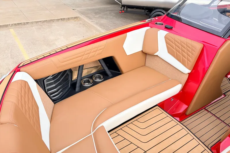 Slide: The Image of Luxurious interior of 2022 Nautique Super Air Nautique G25 boat with tan and white seating. - 17