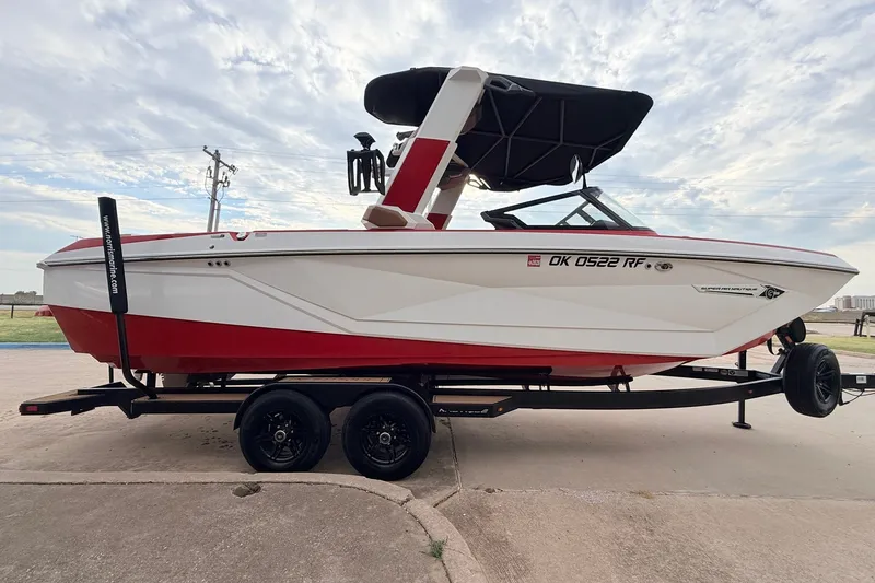 Slide: The Image of 2022 Nautique Super Air Nautique G25 boat on trailer, red and white design. - 4