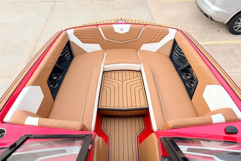 Slide: The Image of 2022 Nautique Super Air Nautique G25 boat interior with tan and white seating. - 15