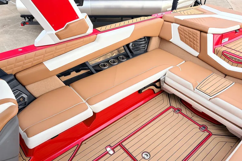 Slide: The Image of Luxurious interior of 2022 Nautique Super Air Nautique G25 boat with tan and white seating. - 33